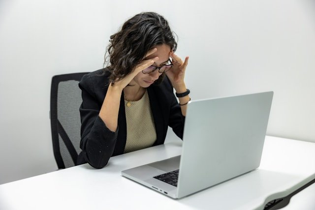 A manager experiencing the stress of poor KPIs resulting from a bad executive hiring decision